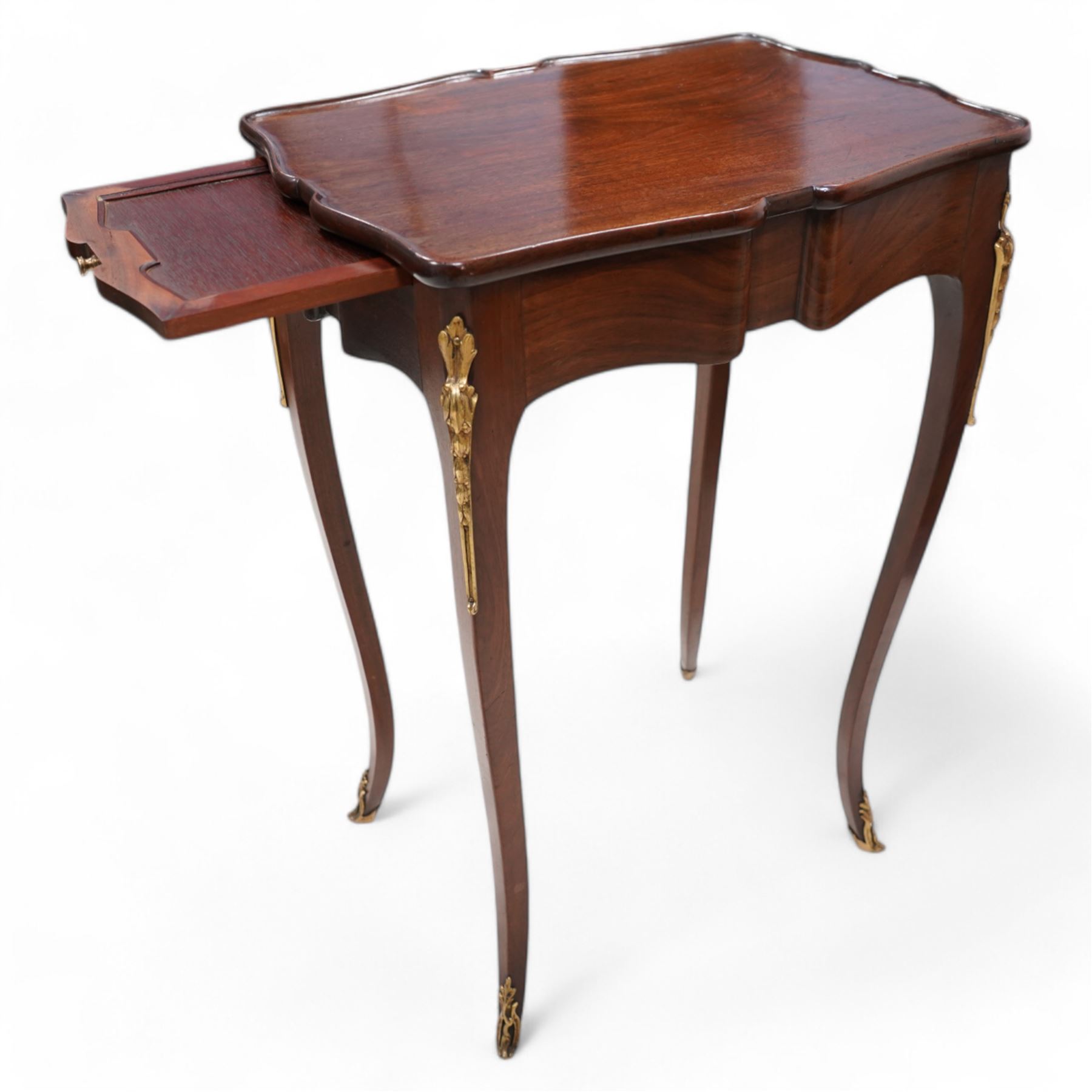 Mid-to-late 20th century French mahogany side table, shaped form with lipped top, single end drawer and opposing slide, on gilt metal mounted cabriole supports 