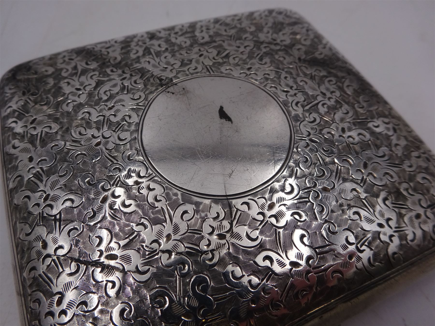 Late Victorian cigarette case, the hinged cover with engraved scrolling decoration and blank central circular cartouche, hallmarked Horton & Allday, Birmingham 1898, H8cm