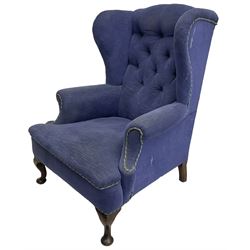 Early 20th century wingback armchair, upholstered in buttoned blue fabric, rolled and scrolled arms, on cabriole feet