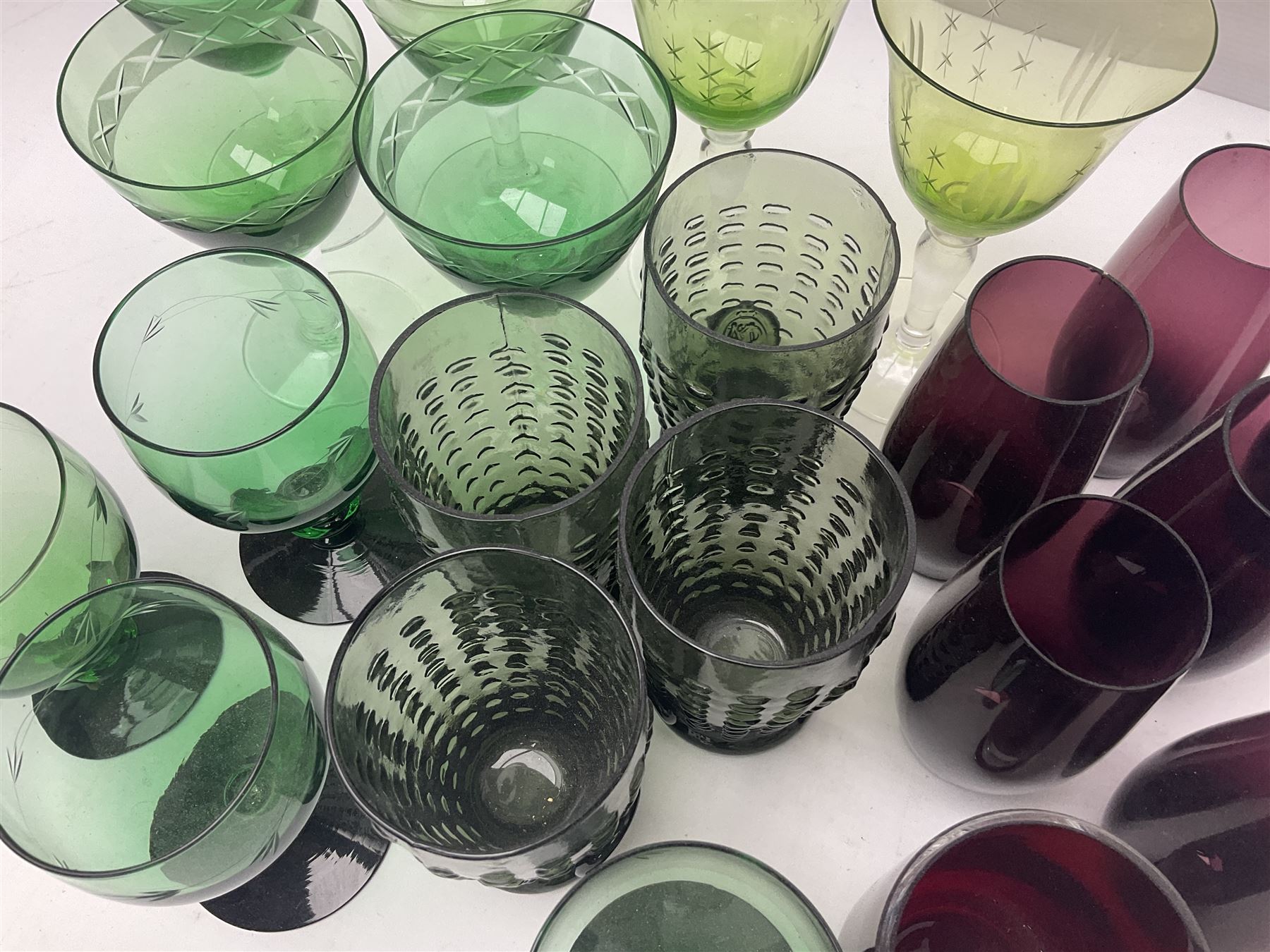 Set of four Swedish Reijmyre drinking glasses, with textured outer surface, together with green drinking glasses including Holmegaard examples and other glassware