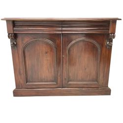 Victorian mahogany chiffonier, raised shaped back with foliage scroll carved mounts, on fretwork and carved bracket supports, moulded rectangular top over two frieze drawers and double panelled cupboard, on moulded plinth base