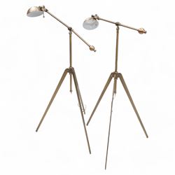 Two burnished metal adjustable tripod standard lamps