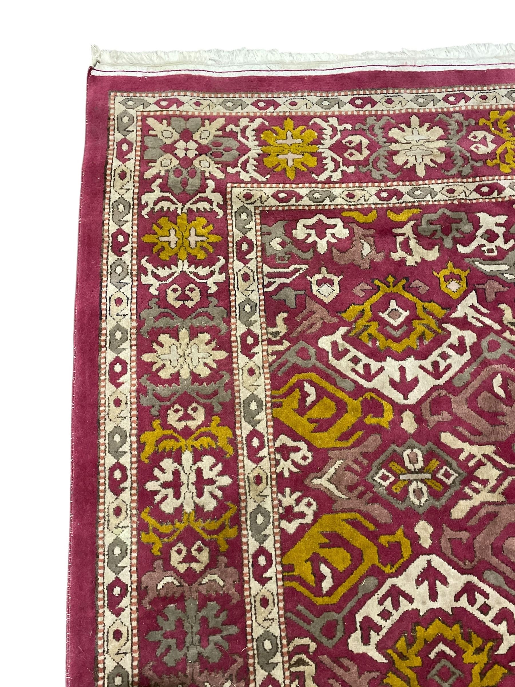 Persian design red ground rug, decorated with stylised plant motifs, repeating border within Boteh decorated guard stripes 