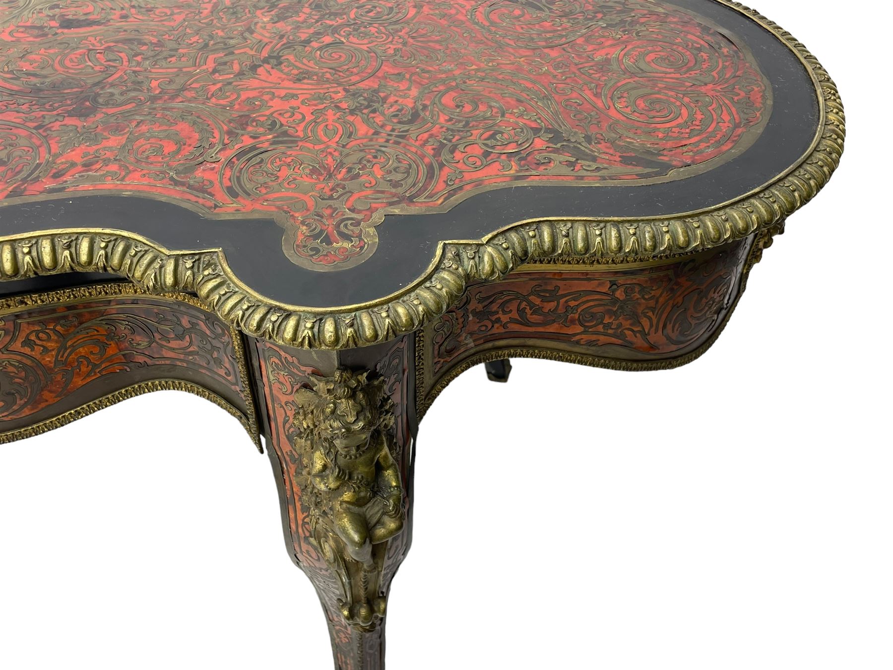 Victorian Louis XV design boulle work centre table, shaped form, decorated extensively with brass and red tortoise shell scroll work, central extending acanthus leaves surrounded by scrolling foliage, gardroon and floral cast brass edge, the frieze rails decorated with further boulle work and green man gilt metal cast masks, the cabriole supports mounted by seated putti mounts on S-scroll brackets surrounded by oak leaves and acorns, ornate scroll and floral cast terminal caps