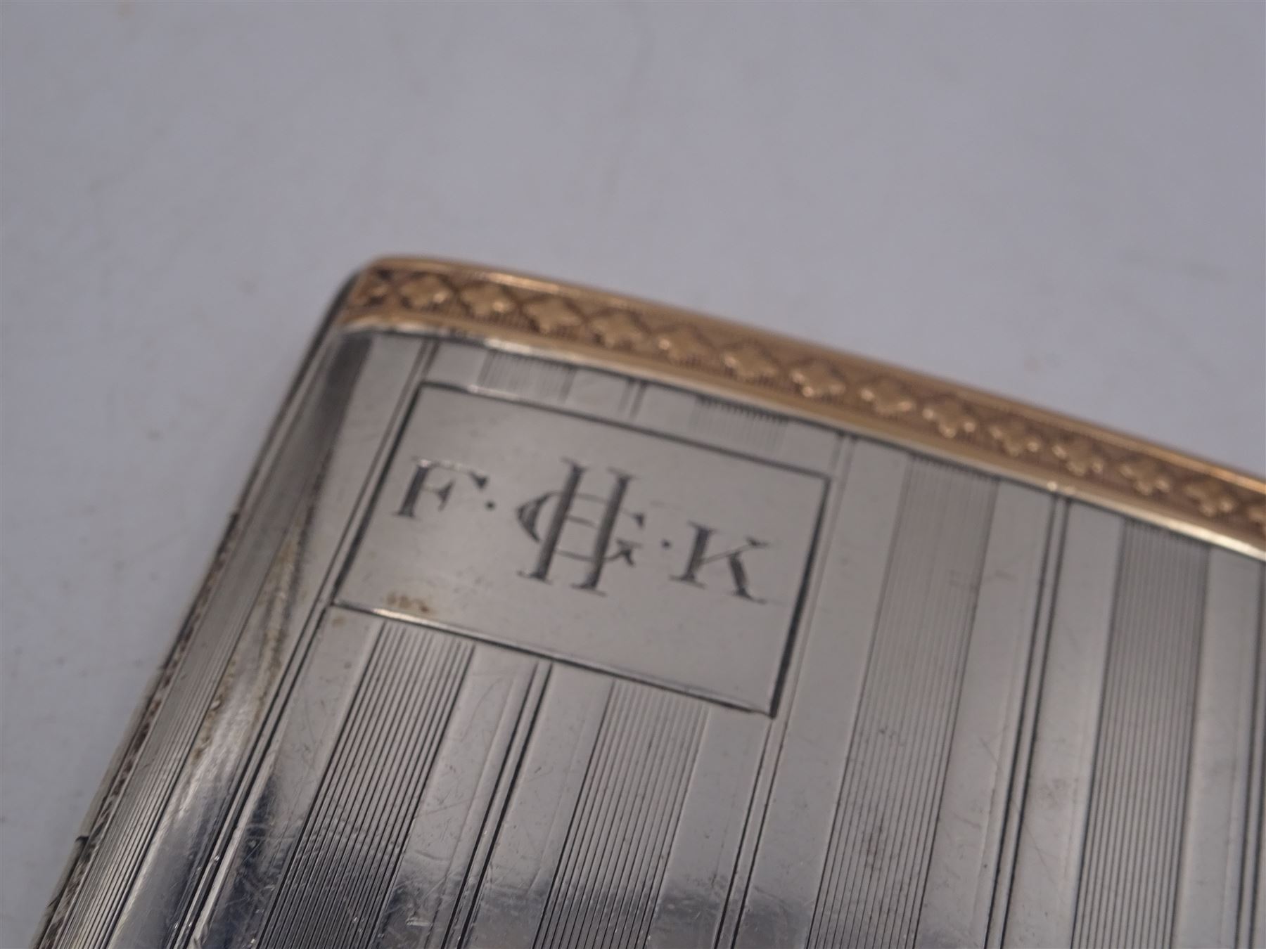 1920s silver cigarette case, of rectangular form with engine turned decoration and bands of embossed rose gold decoration either side, with engraved cartouche, hallmarked William Neale & Son Ltd, Birmingham 1924, H8.4cm