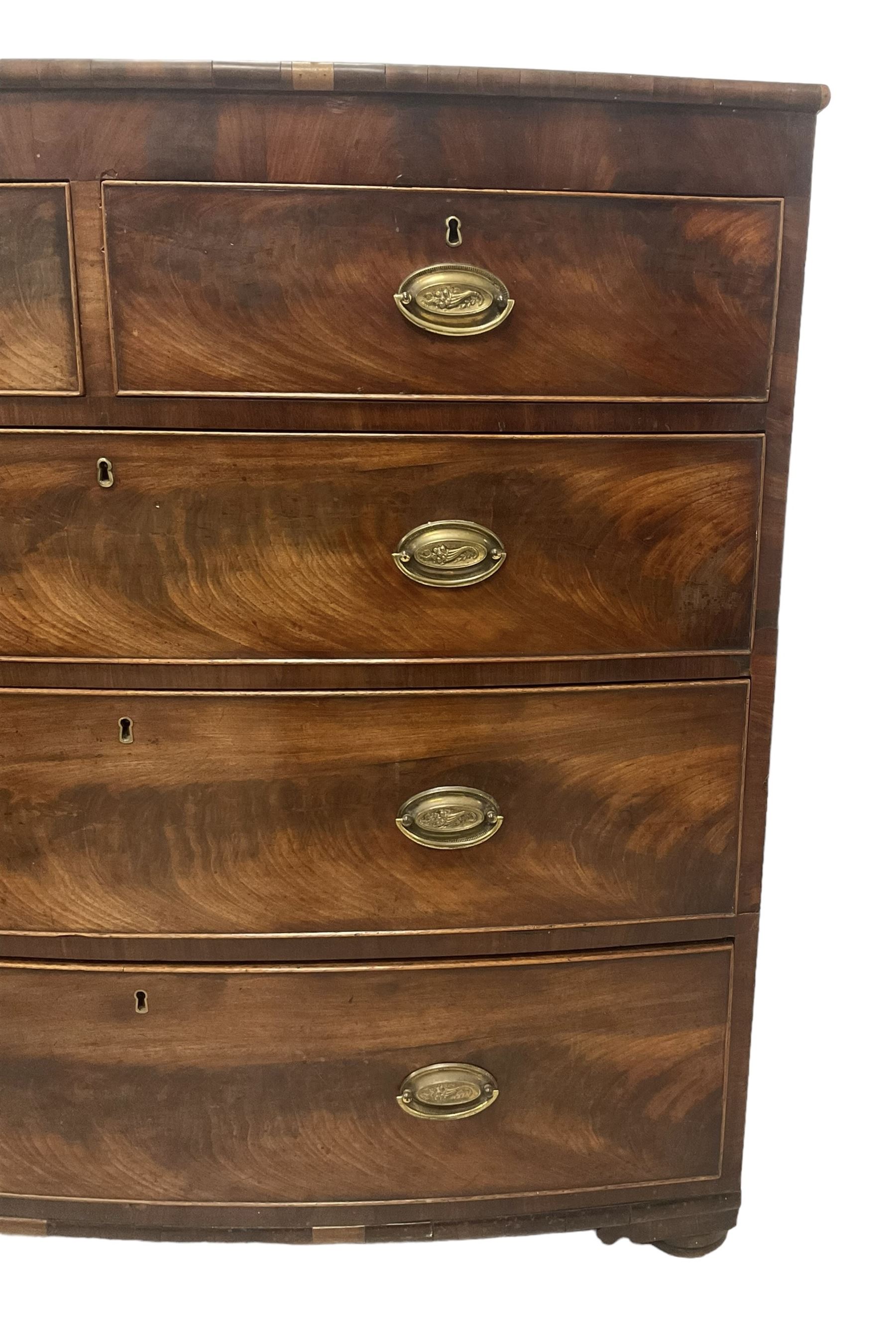 George III mahogany bow-front chest, fitted with two short over three long graduating cock-beaded drawers, on compressed bun feet