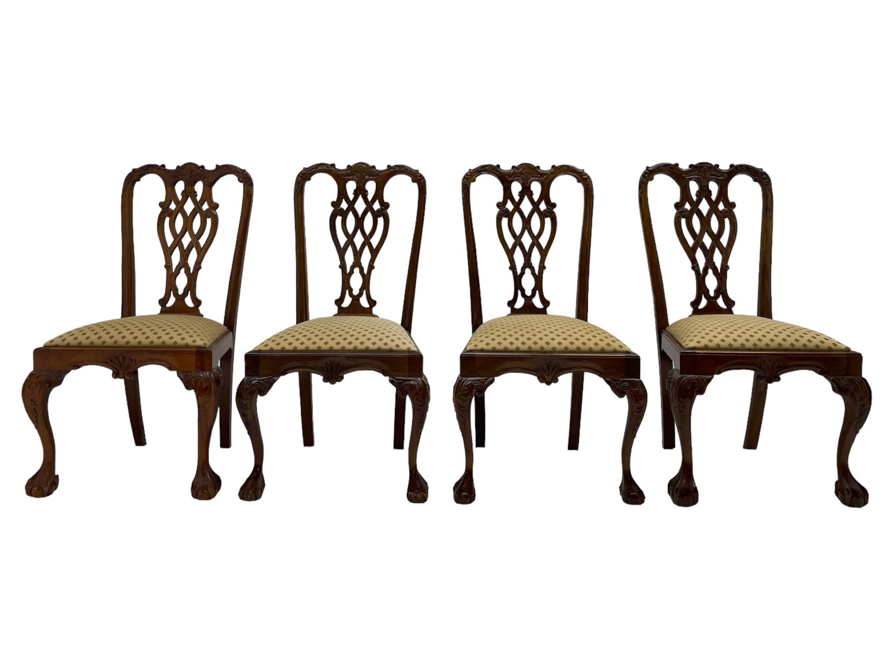 Set of twelve Chippendale design mahogany dining chairs, shaped cresting rail carved with foliage and C-scrolls, pierced interlaced splat with curled leaf decoration, upholstered drop-in seat, moulded seat rails, on scrolled acanthus carved cabriole supports with ball and claw feet 