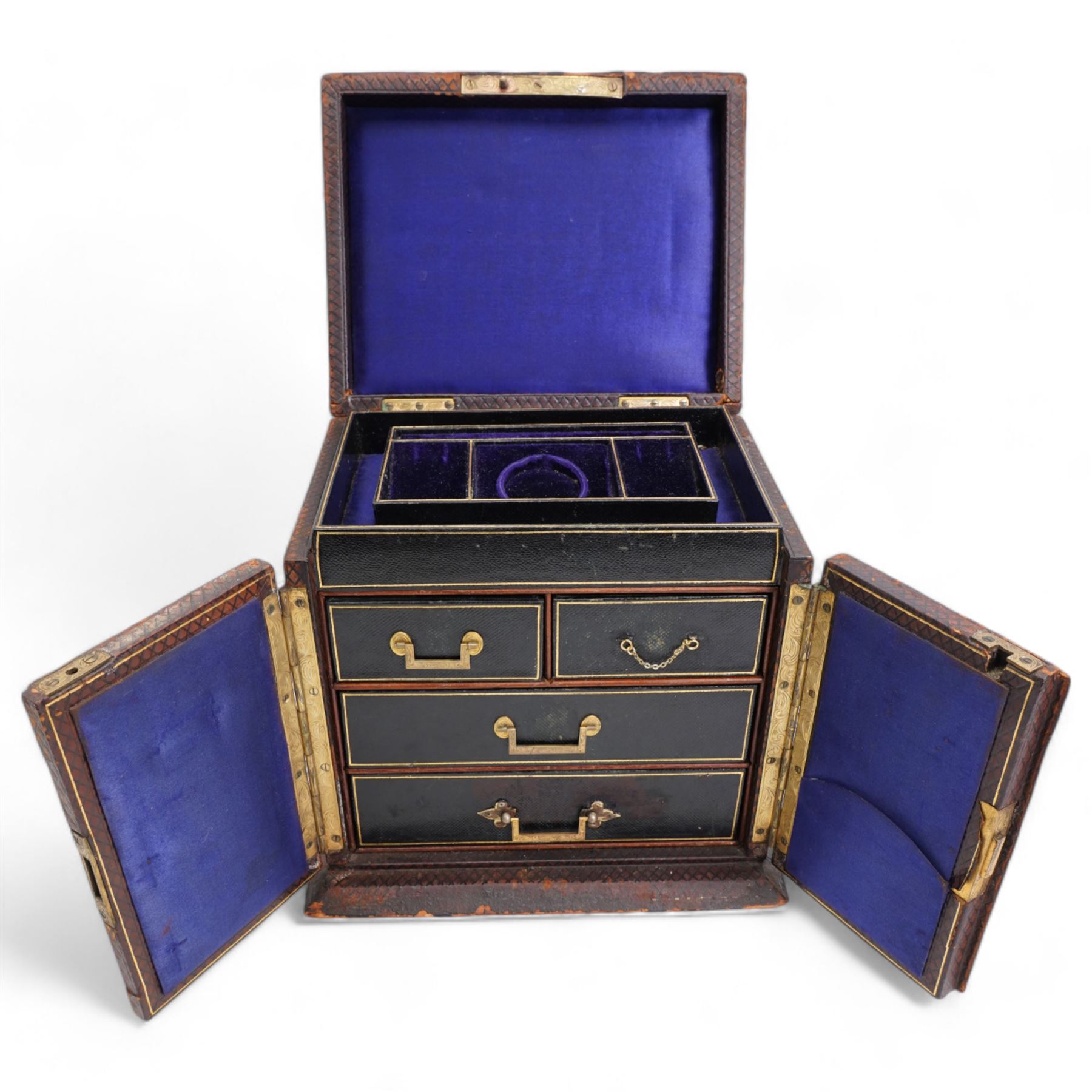 Victorian tooled leather jewellery casket, the cover with inset brass handle, two hinged doors open to reveal a top inset lined tray and central pocket watch, above two short and two long drawers, H22cm, W24.5cm, D19.5cm 