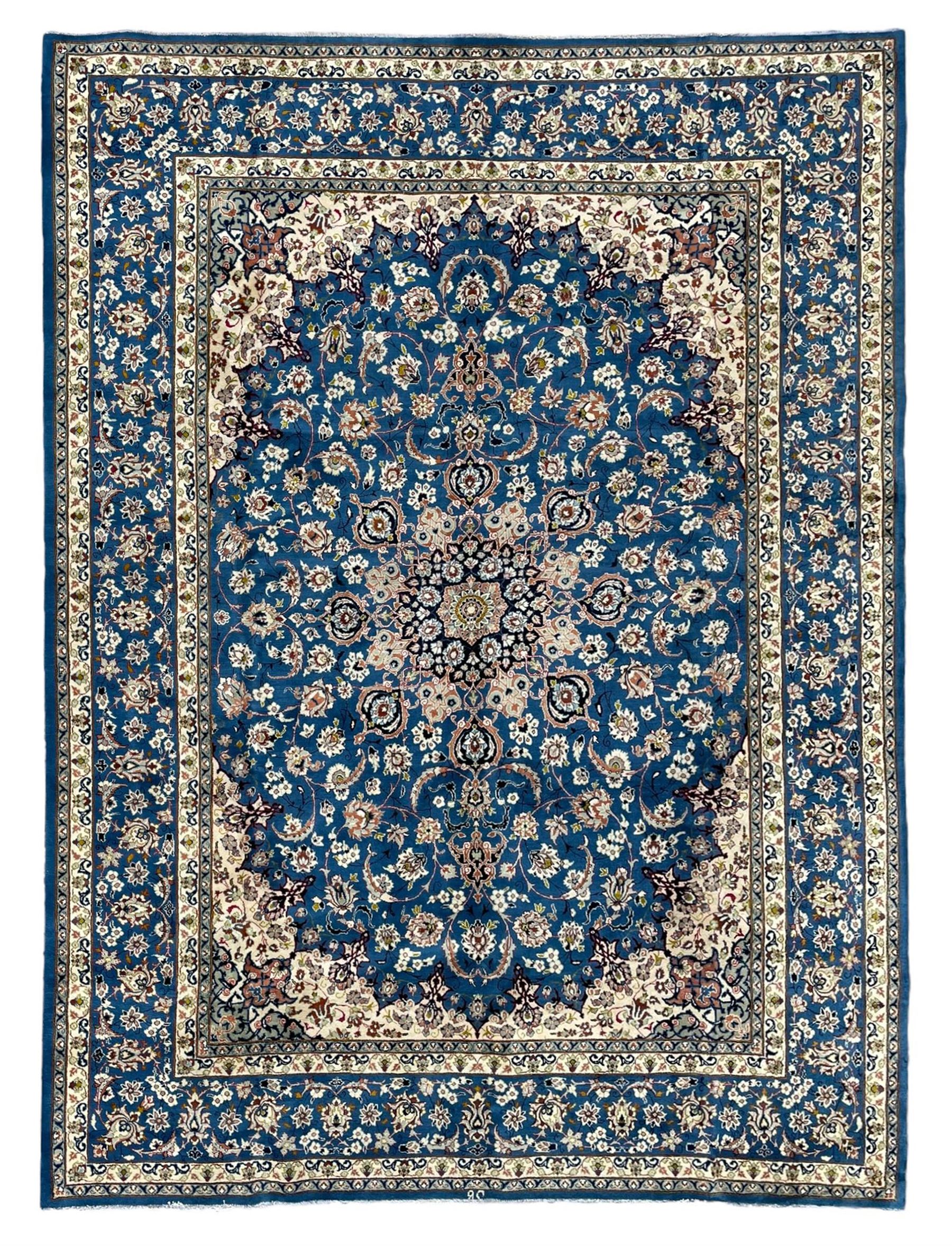 Persian Nain blue ground carpet, overall arabesque design, centre rosette medallion with eight projecting palmettes, the surrounding field decorated with interlacing branches and stylised plant motifs, within floral pale ground spandrels, the guarded border decorated with repeating stylised floral pattern 