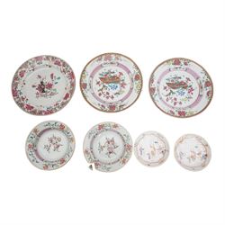 Pair of 18th century Chinese Export famille rose porcelain dishes, enamelled with figures and children in a garden setting within an iron red quatrefoil border, D12cm, together with three famille rose plates, D23cm and two bowls (7)