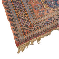 Old Persian red ground flat woven carpet, the field with three large medallions surrounded by small stylised flower head motifs, geometric border enclosed within running water band 346