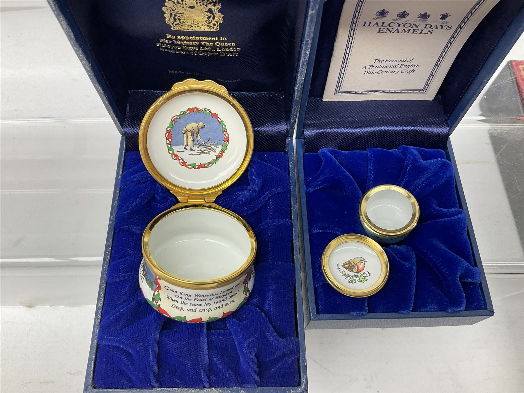 Eight Christmas themed Halcyon Days enamel boxes, and a Halcyon Days enamel bonbonniere modelled as a snowman, each in fitted box 