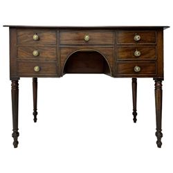 George III mahogany kneehole dressing or side table, moulded rectangular top over seven cock-beaded drawers, on ring turned support 