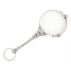 Early 20th century platinum and diamond lorgnette, the milgrain set rose cut diamond handle, with flower head terminals, the reverse with engraved foliate decoration, to spring-loaded glass lenses