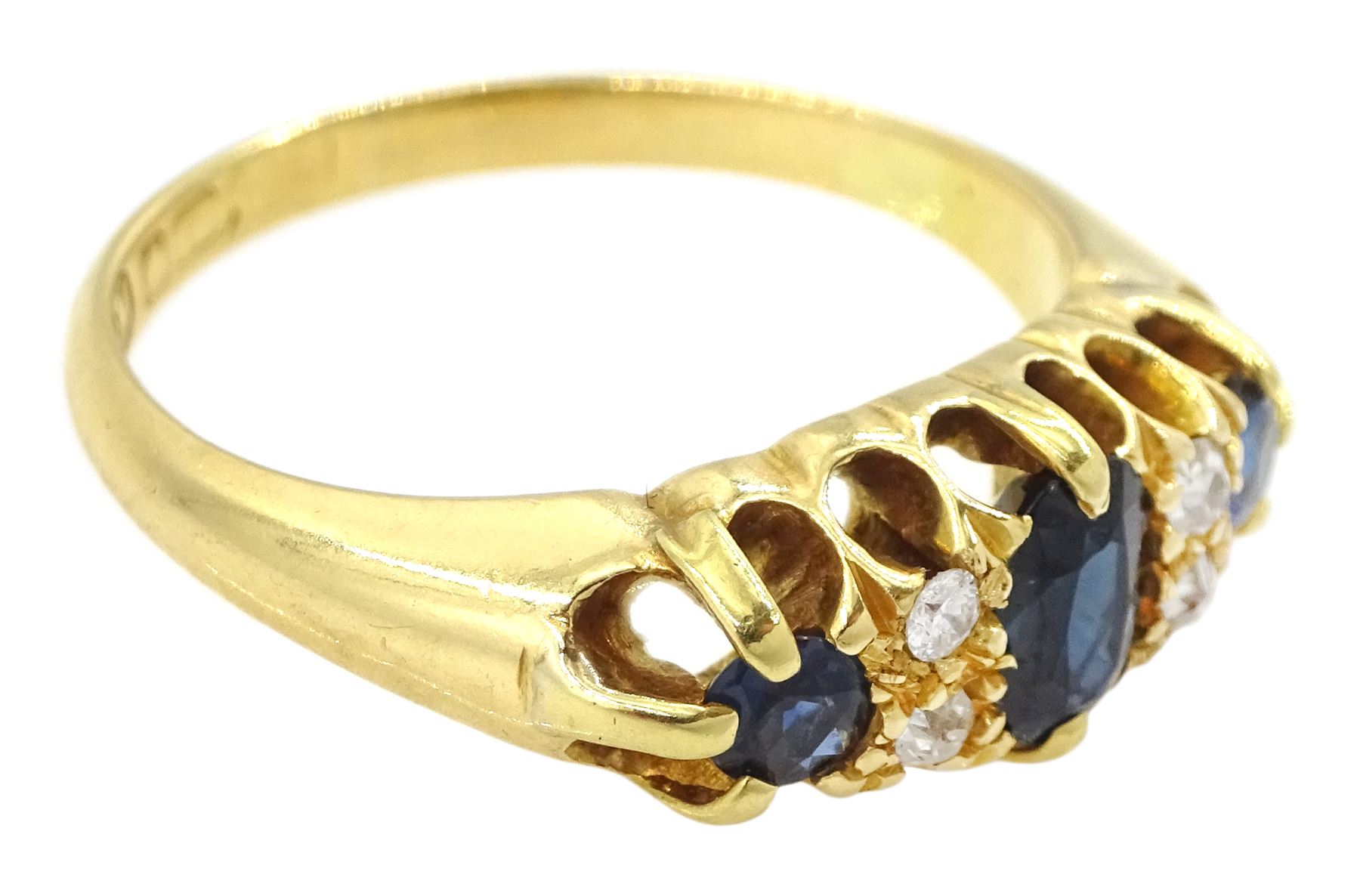 Early 20th century 18ct gold three stone sapphire and four stone old cut diamond ring