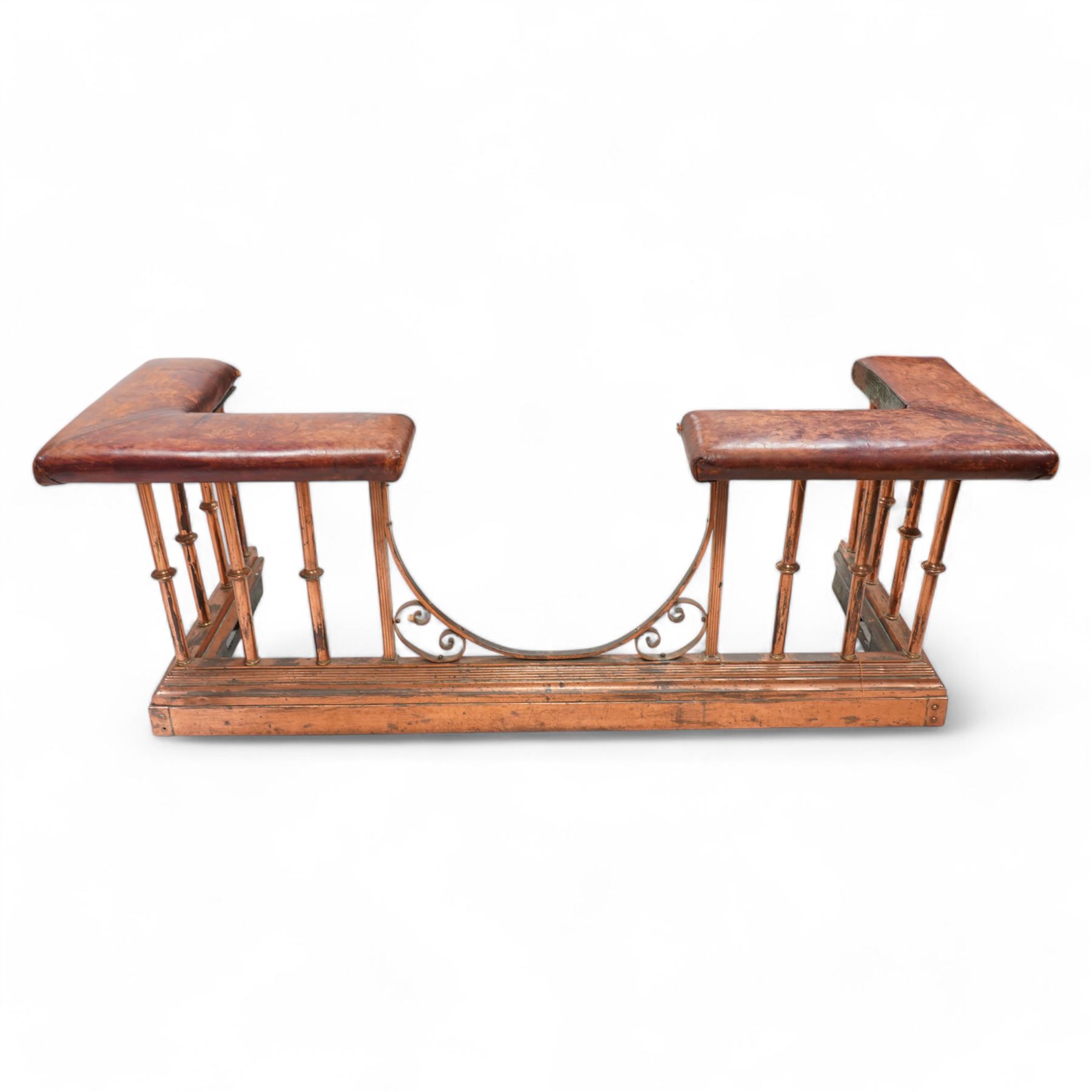 Victorian copper club fender, leather upholstered cushioned seats on turned balustrade supports, drop centre with C-scroll corner brackets, on stepped moulded curb 