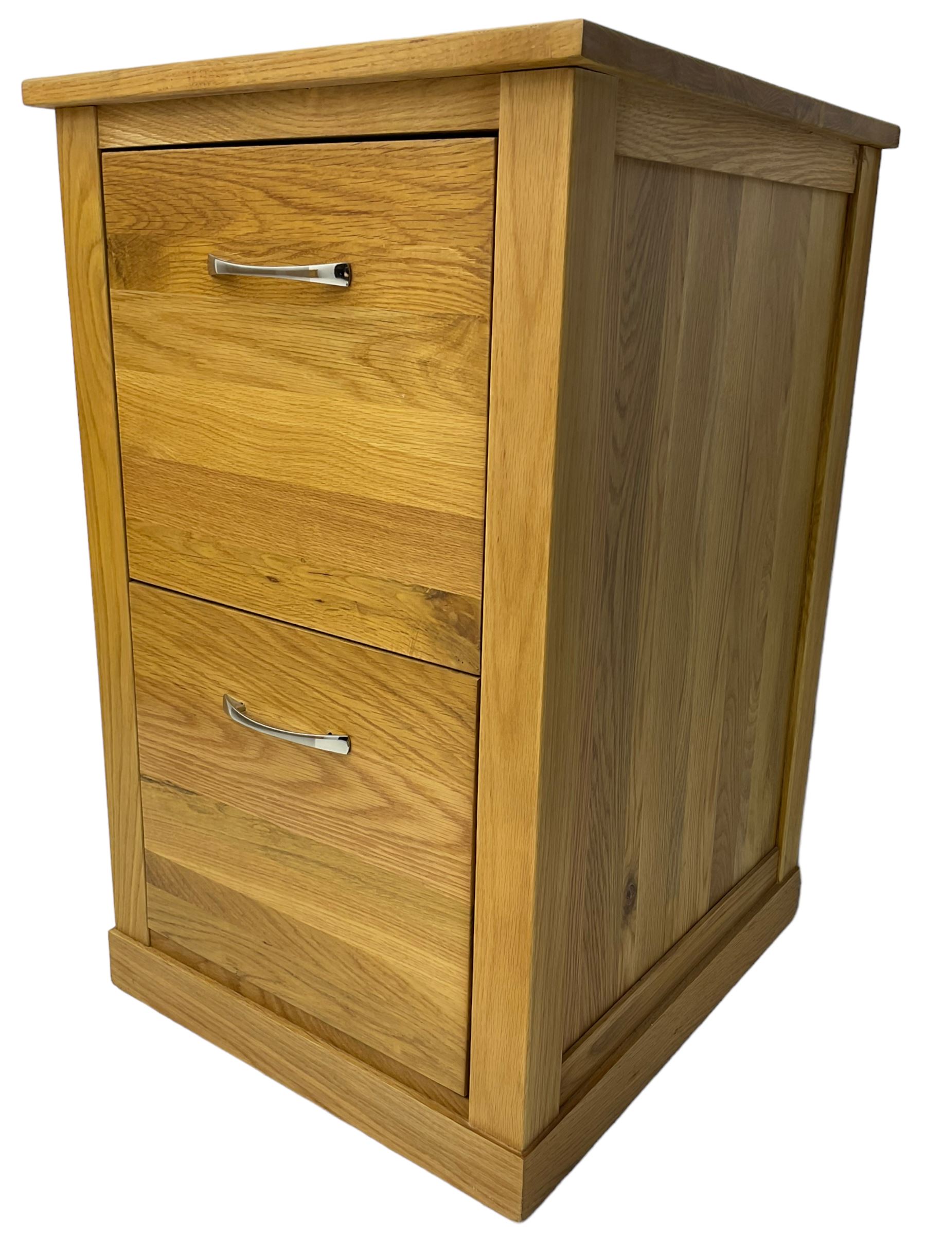 Contemporary light oak filing cabinet, rectangular top over two drawers each fitted with metal rods, on plinth base