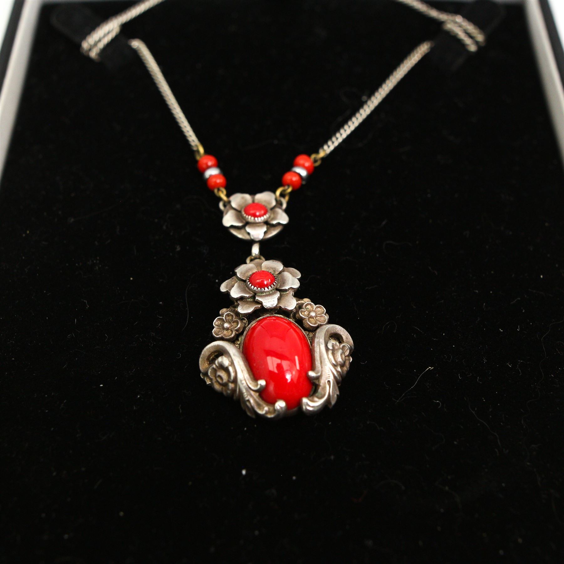 Group of silver jewellery, including three large gem set pendant necklaces, a red coral fancy floral pendant necklace and a moss agate bracelet