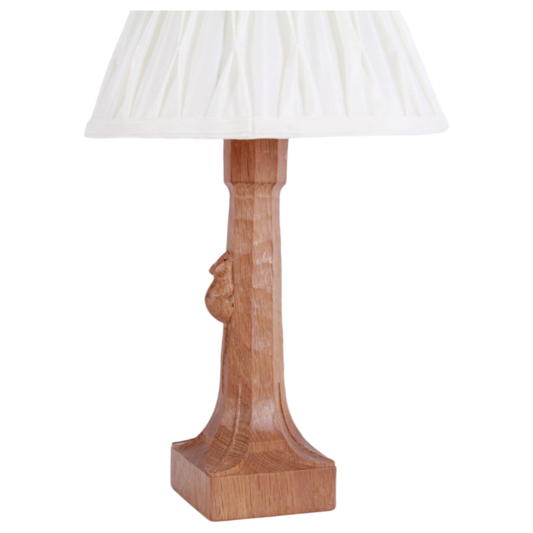 'Mouseman' tooled oak table lamp, tapered octagonal stem terminating to leaf carved square base, carved mouse signature, with pleated cream shade, by Robert Thompson of Kilburn