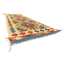 Kilim runner rug, central field decorated with four stacked geometric medallions in a multicoloured zigzag design, bordered by a series of small geometric motifs, fringed edges at both ends