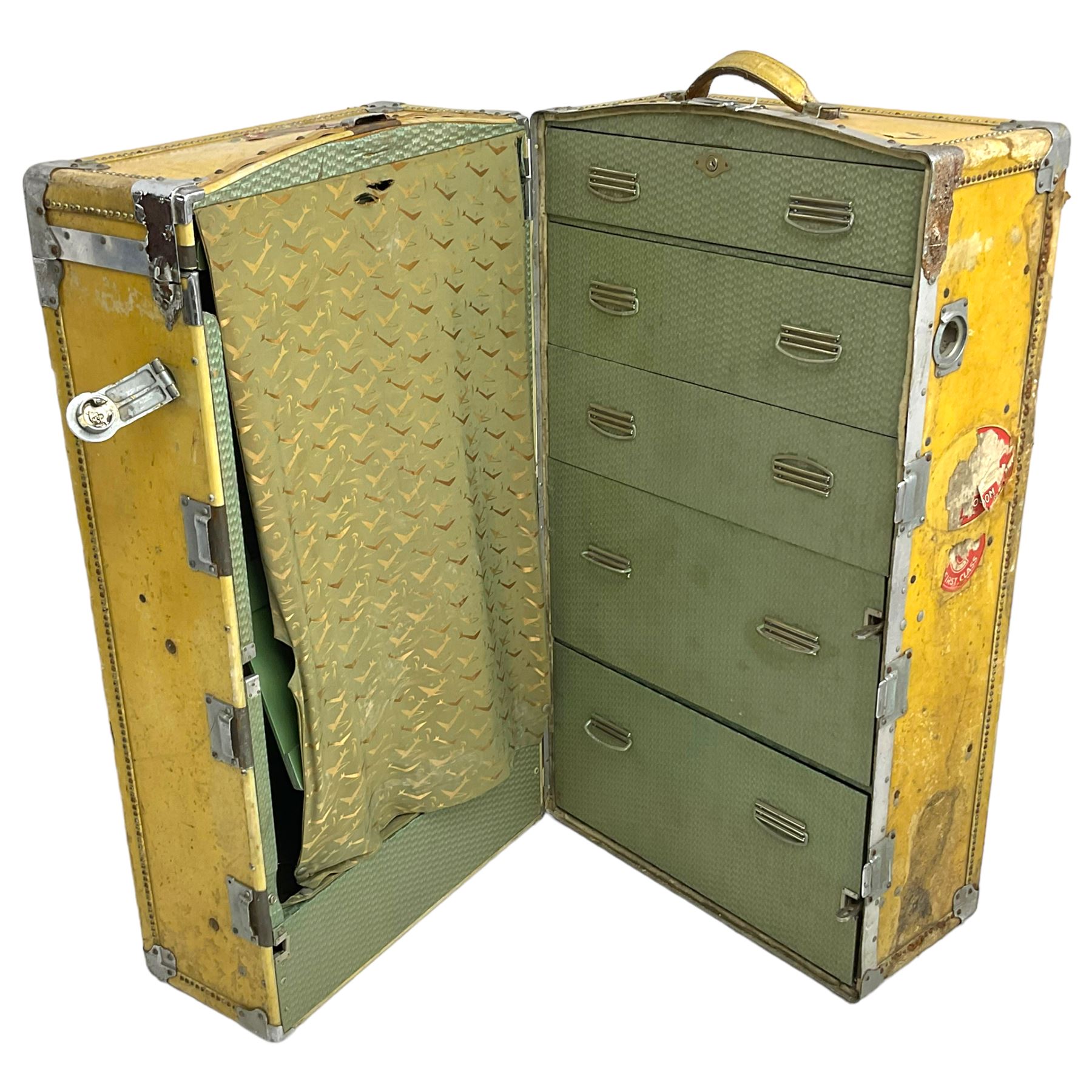 Early 20th century steamer traveling trunk, in yellow finish with chrome fixtures, the interior fitted with drawers and hangers, with various travel labels 