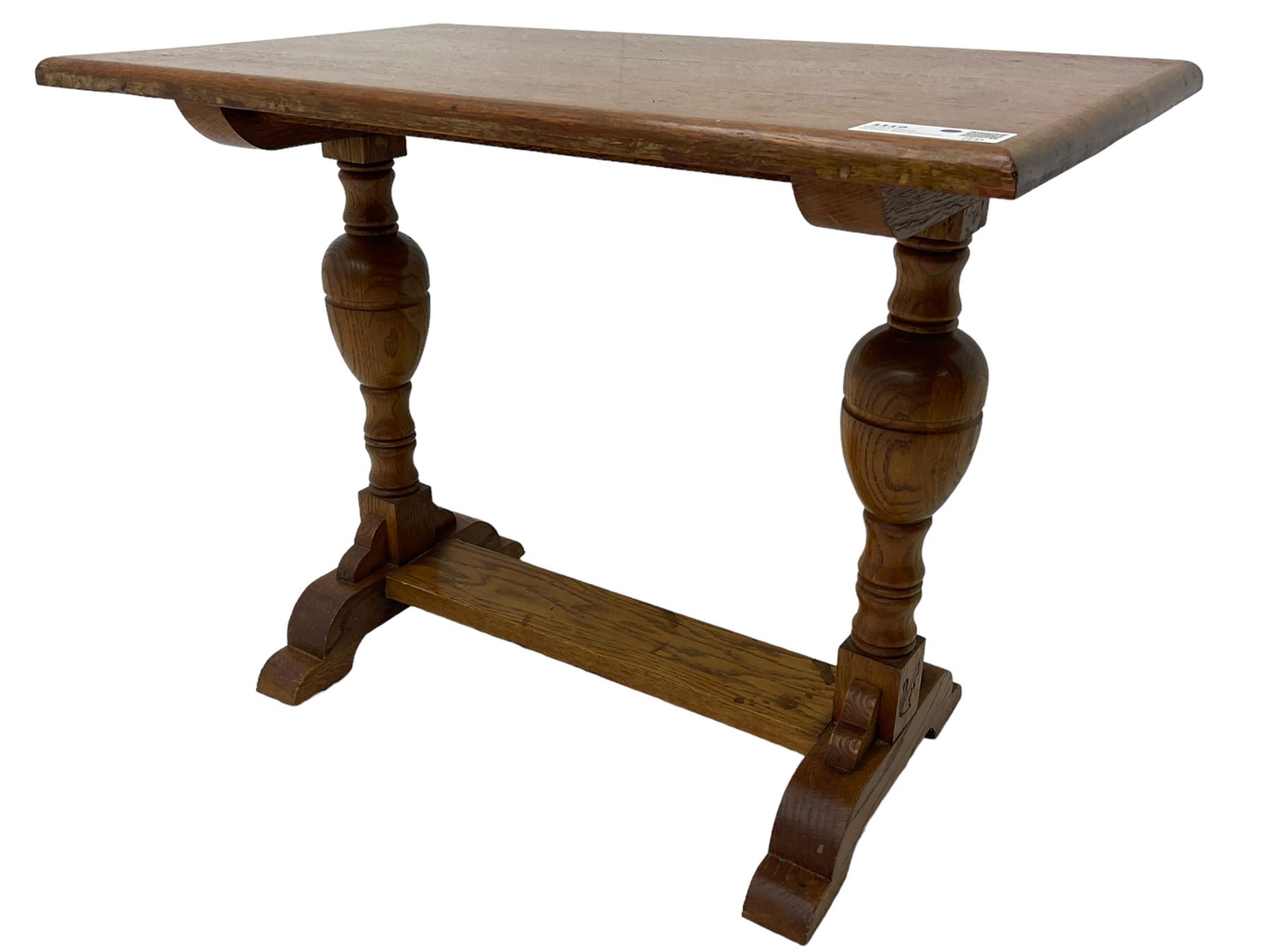 20th century oak occasional table, rectangular top on turned twin pillar supports, carved with squirrel motif, on shaped sledge feet united by stretcher 