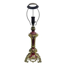 Late 19th century gilt metal mounted table lamp, the burgundy porcelain body of tapering form with applied gilt metal acanthus feet leading to cherub masks, overall including fixtures H59cm