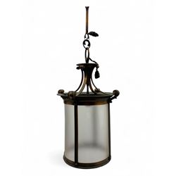 Early 20th century brass hanging lantern with frosted cylindrical glass, scrolling support...