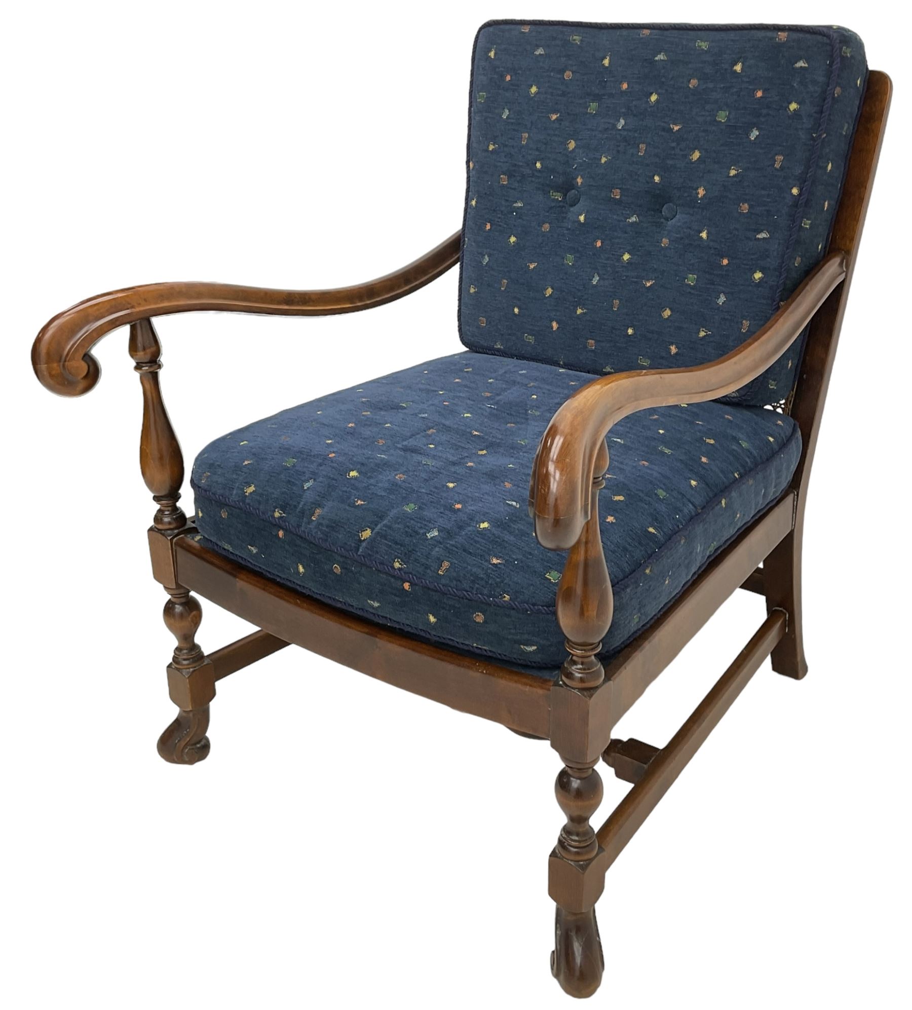 Early 20th century stained beech framed armchair, cane panel back over scrolled arm terminals, raised on turned supports united by turned H-stretcher, with patterned blue upholstered loose back and seat cushions