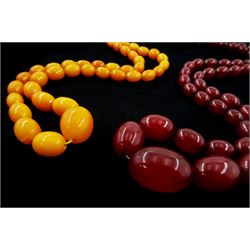 Single strand graduated oval amber bead necklace and a cherry amber type bead necklace