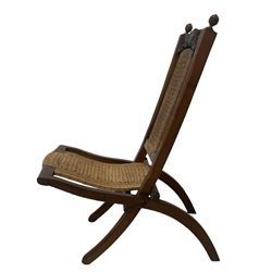 Victorian Aesthetic Movement mahogany framed folding campaign chair, pierced and carved cresting rail with carved and chamfered uprights, rattan back and seat