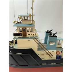 Modern model of American Coastal and River Tugboat 'Maya', in red, black and light blue finish, upon a green stand inscribed with name, H53cm, W52cm 