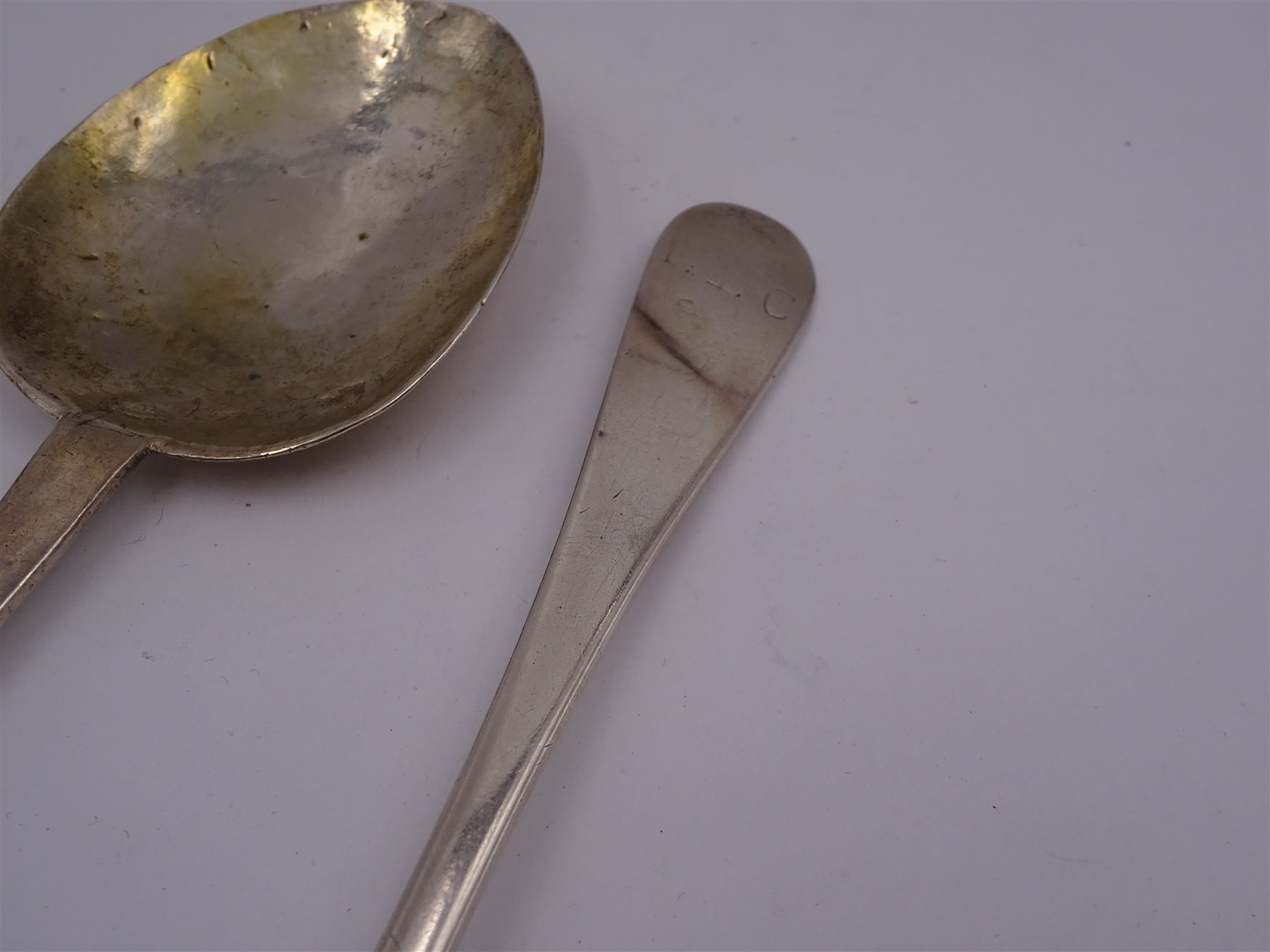 17th century silver trifid spoon, marks worn and indistinct, together with an Old English pattern silver spoon