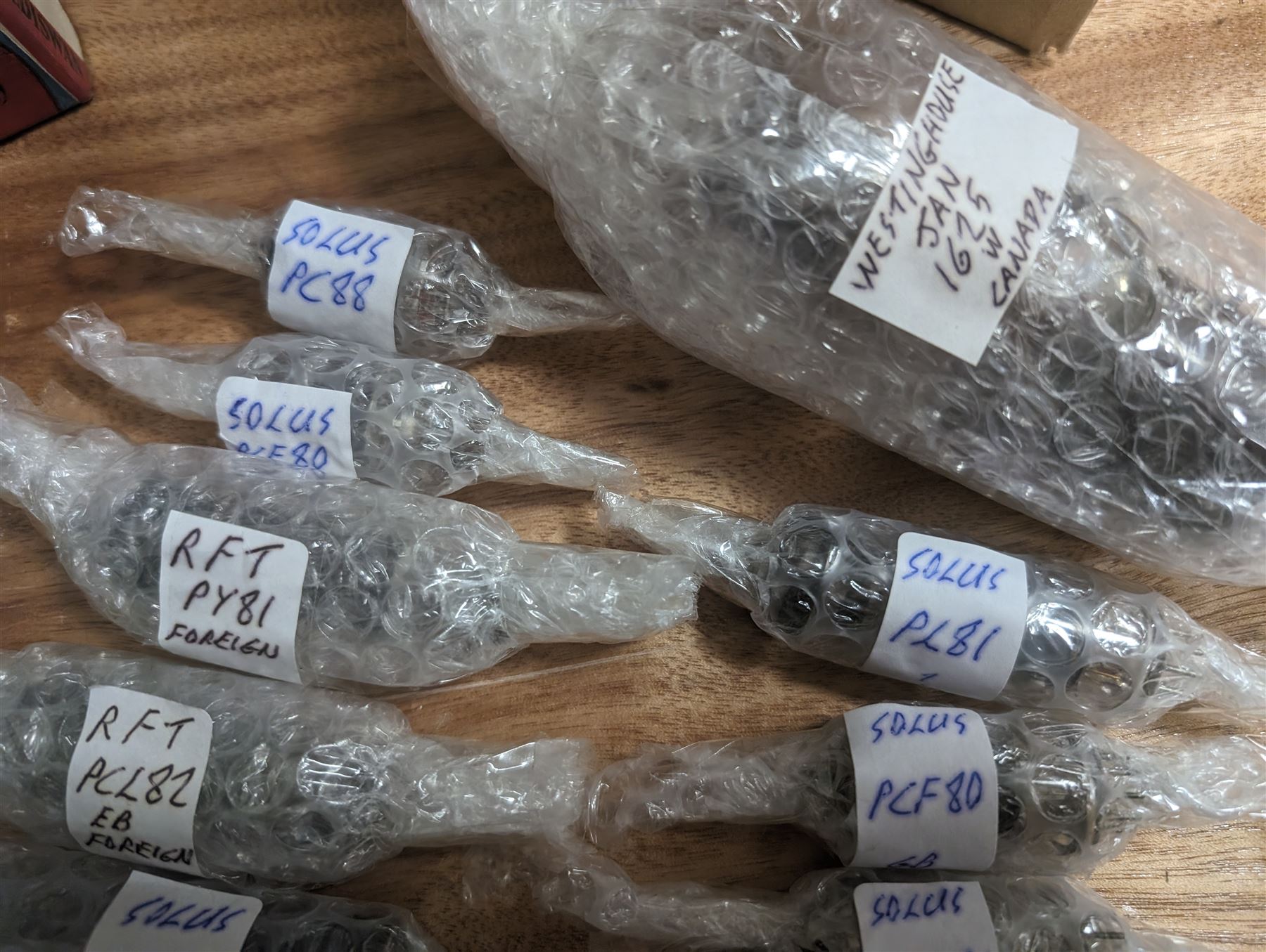 Large collection of thermionic valves/vacuum tubes, by various makers, mostly wrapped in bubble wrap with identifying stickers, together with a collection of empty valve boxes including Pinnacle, Mullard etc