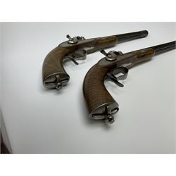 Pair of Muller & Lyon 11mm (approx. .42 cal.) percussion target pistols each with 24.5cm rifled octagonal and fluted barrel, plain action and hammer, unchequered walnut stock with inverted crown shaped butt plate and hooked trigger guard, no set trigger or half cock safety, numbered 1 & 2 on top of breech, L42cm overall; in baize lined fitted walnut case with all accessories including miniature copper powder flask, scissor action bullet mould, nipple key with screw-driver attachment, turned hardwood mallet and graduated pair of lidded boxes, brass rammer, cleaning rod etc, case L55.5cm