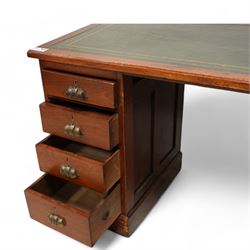 Early 20th century walnut twin pedestal desk, moulded rectangular top with inset green leather writing surface, fitted with eight drawers with brass cup handles, on plinth base