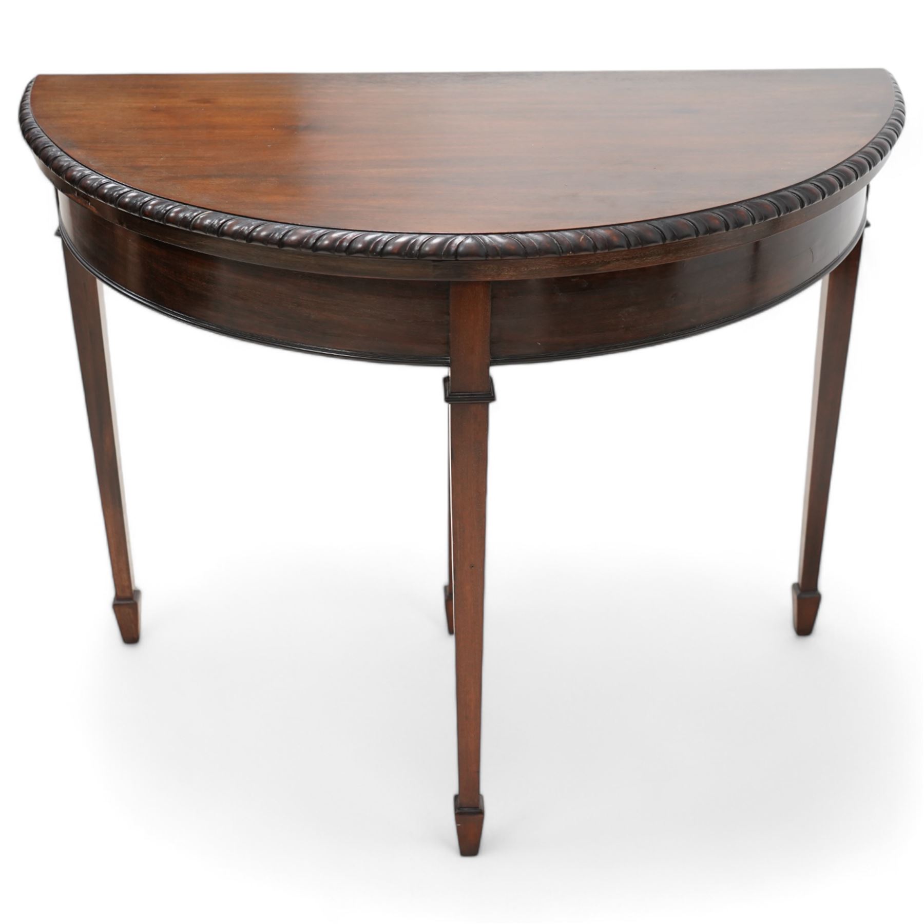 20th century mahogany demi-lune card table, fold-over top with gadrooned edge revealing baize playing surface, single pull-out rear support, on square tapering supports with spade feet