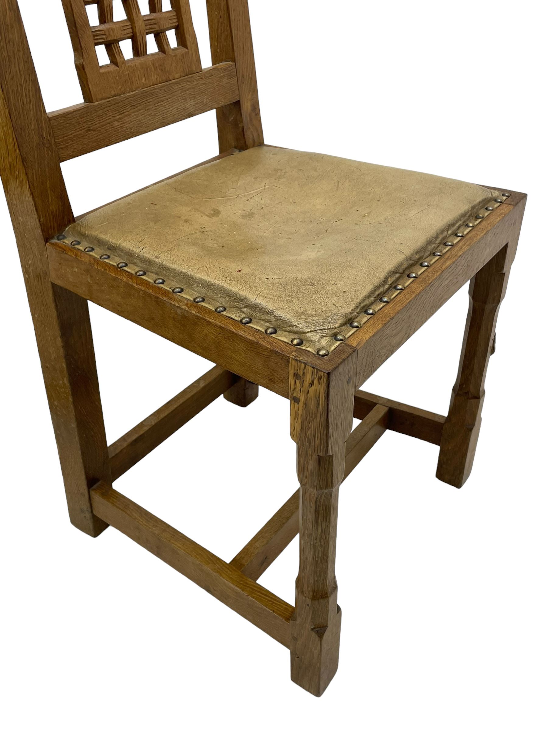 Rabbitman - set of six (5+1) oak dining chairs, pierced and carved lattice back, leather upholstered seat with stud band, on octagonal supports united by stretchers, carved with rabbit signature, by Peter Heap of Wetwang 