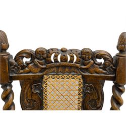 Set six 19th century oak Carolean style dining chairs, the cresting rail with open crown flanked by putto, spiral turned uprights with pineapple finials, canework seat and back, the seat rails carved with foliage, spiral turned supports joined by s-scroll and open crown carved front rail, decorated with flower heads, each with upholstered seat pad