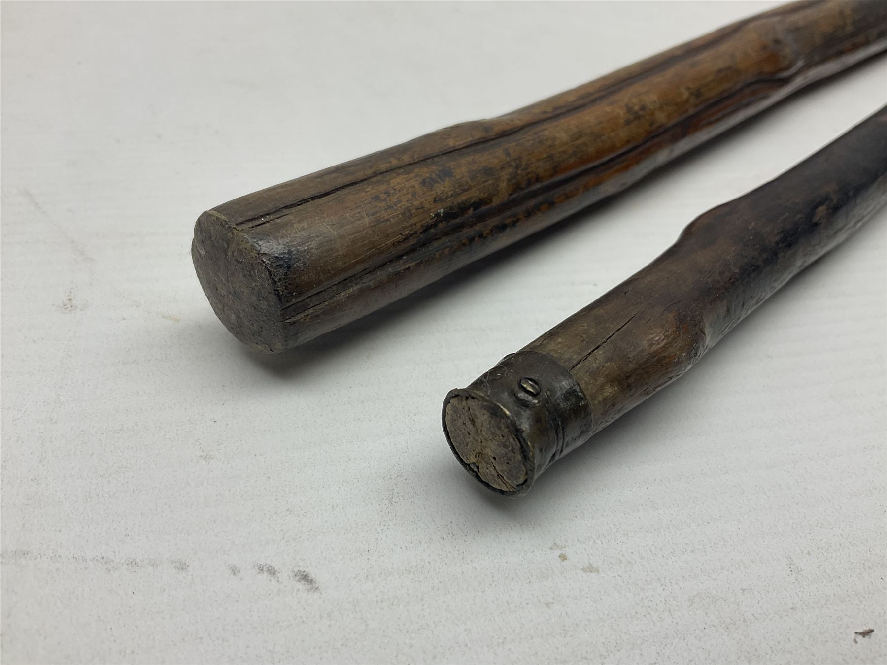 Two wooden walking sticks, both with comparts that would have housed horse measures, H88cm