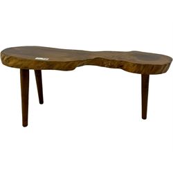 Mid-20th century live edge walnut coffee table, the top showcases the natural grain and organic form of the wood, supported by three tapered legs 