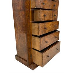 Victorian burr walnut Wellington chest, rectangular top with book-matched veneers, two hinged uprights with scrolled foliage carved brackets enclosing seven graduating drawers, on plinth base 