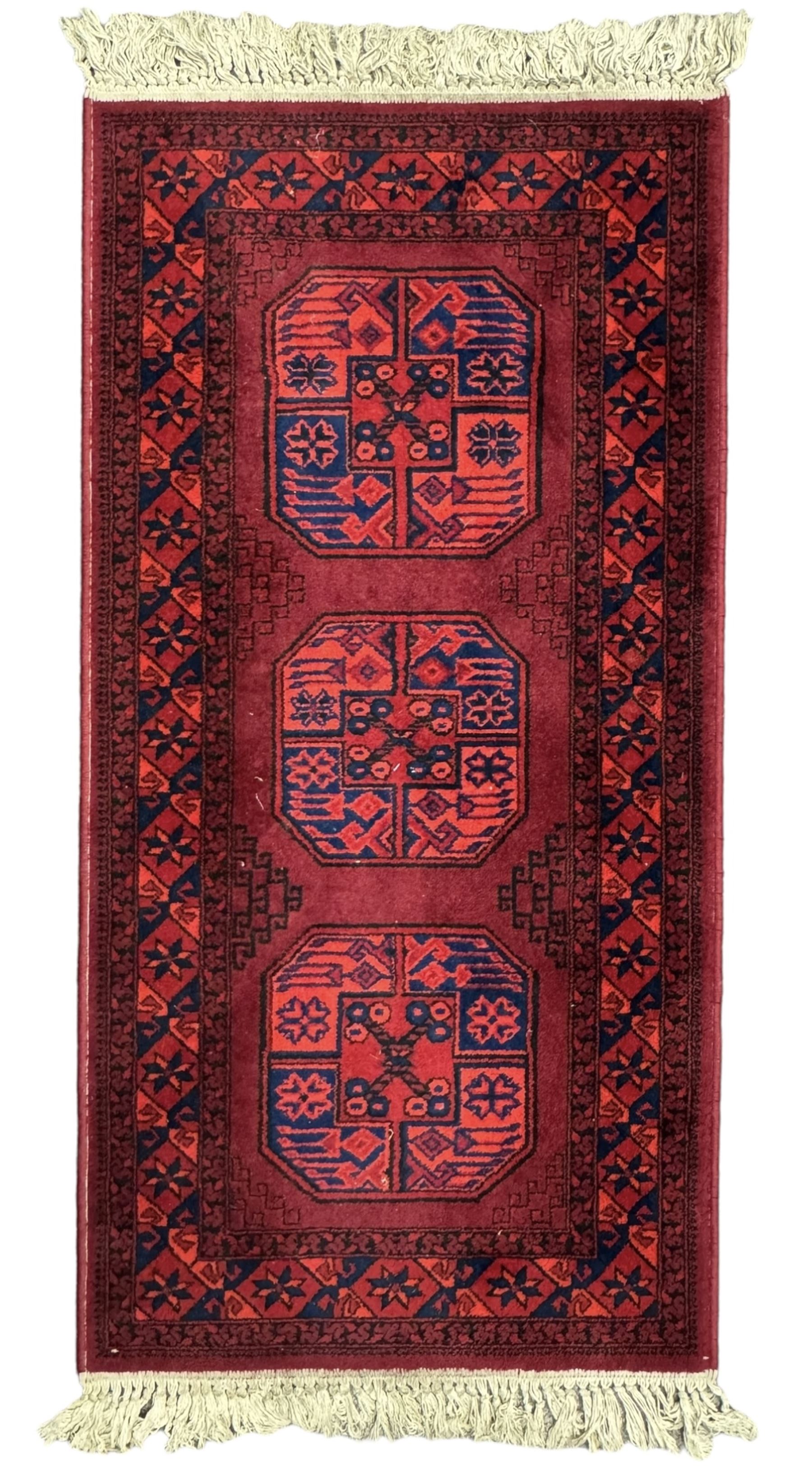 Persian Qashqai crimson ground rug, the field with central indigo and yellow medallion with geometric motifs, flanked by smaller medallions, border with repeating patterns (112cm x 200cm); Turkish Kazak light blue ground rug (109cm x 193cm); red ground runner with three octagonal medallions (69cm x 138cm)