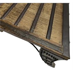 19th century Indian bullock / ox cart converted coffee table, trapezoidal top with applied metal decoration and iron stretchers, raised on three swept supports with stud decoration