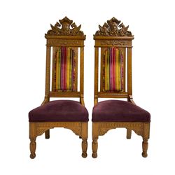 Set of six 20th century Carolean design oak high back chairs, the pediment carved with dragons and central Green Man mask with trailing foliage, the backs upholstered in striped fabric, on turned front supports