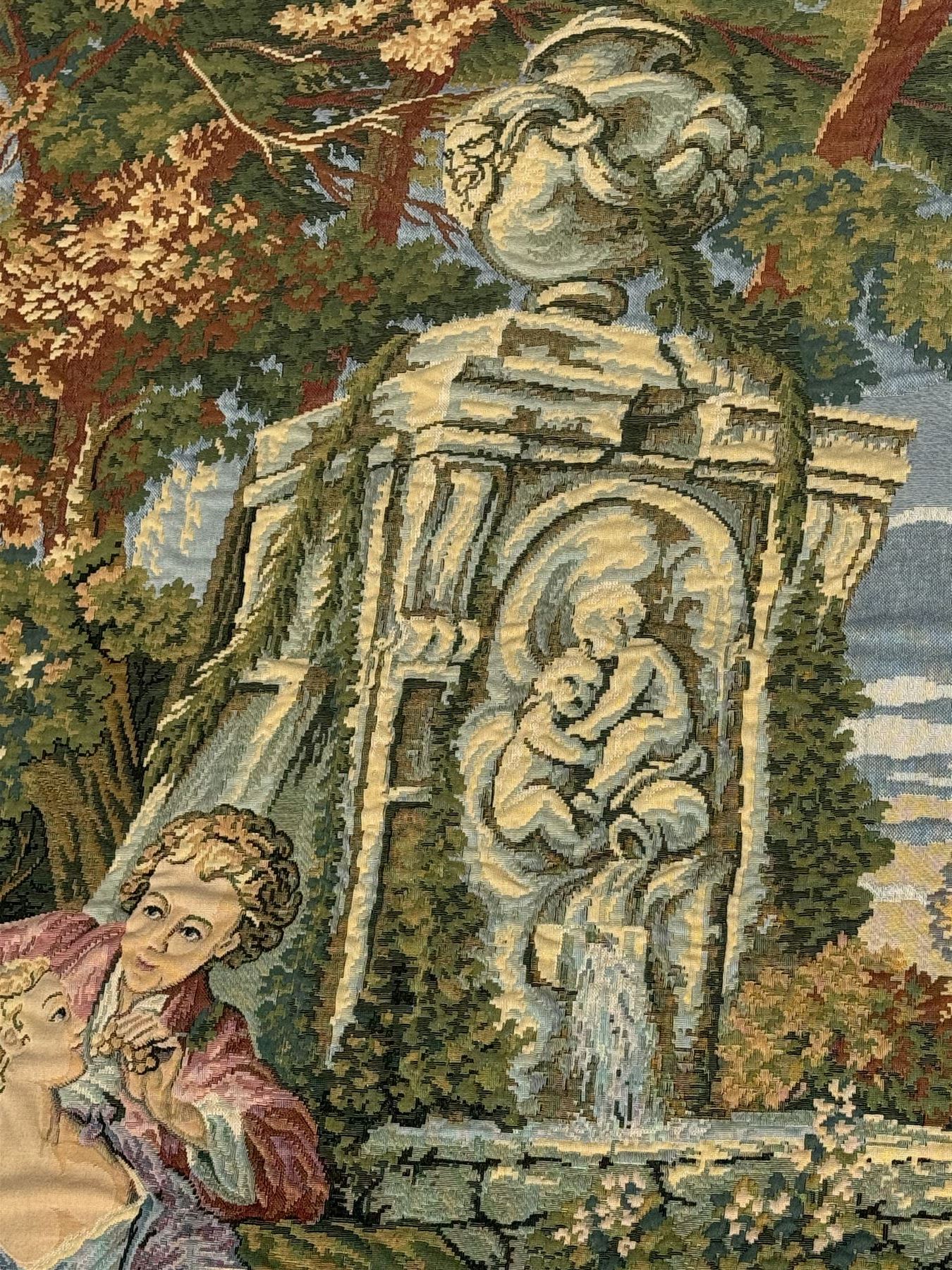 French machine woven tapestry, the scene depicting pastoral life with shepherds and sheep against a backdrop of lush foliage and classical architecture, bordered by a floral and scroll design