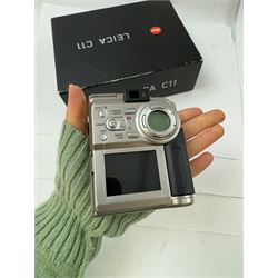 Leica C11 APS film compact camera, in silver and chrome finish, serial no. 2636834, in original clear hard case and box, with instruction booklet, together with a Leica Digilux 4.3, with 1:2.8-4.5/8.3-24.9mm lens, serial no. 2598862, with instruction booklet