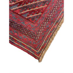 Meshwani indigo and maroon ground rug, the field decorated with a central lozenge with concentric borders containing hook motifs, enclosed by geometric zig-zag guard lines