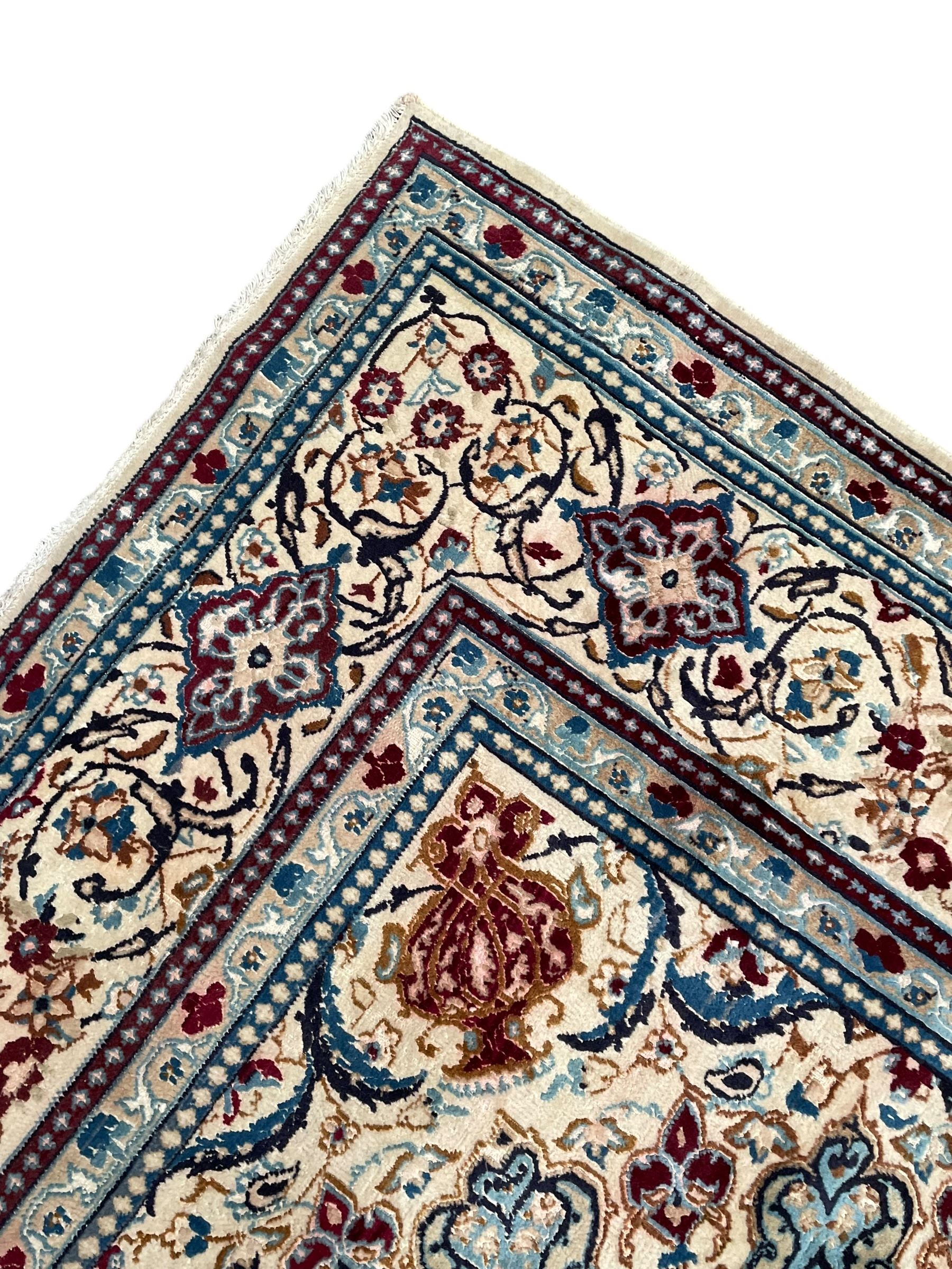 Persian Kashan olive ground carpet, central rosette medallion surrounded by swirling leafy branches and palmettes, the spandrels decorated with further palmettes and foliate motifs, scrolling border interspersed with stylised plant motifs, with in guard stripes