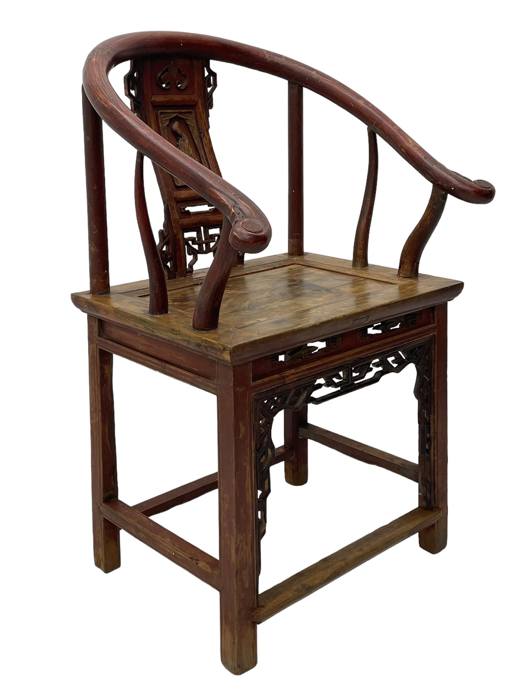 Late 19th century Chinese Qing dynasty horse shoe armchair, in elm, hung mu and Chinese softwood, horse shoe shaped upper rail carved with scroll terminals, shape back carved with solitary figure in robes, rectangular panelled seat in moulded frame, decorated with fretwork panels, on square supports united by stretchers 